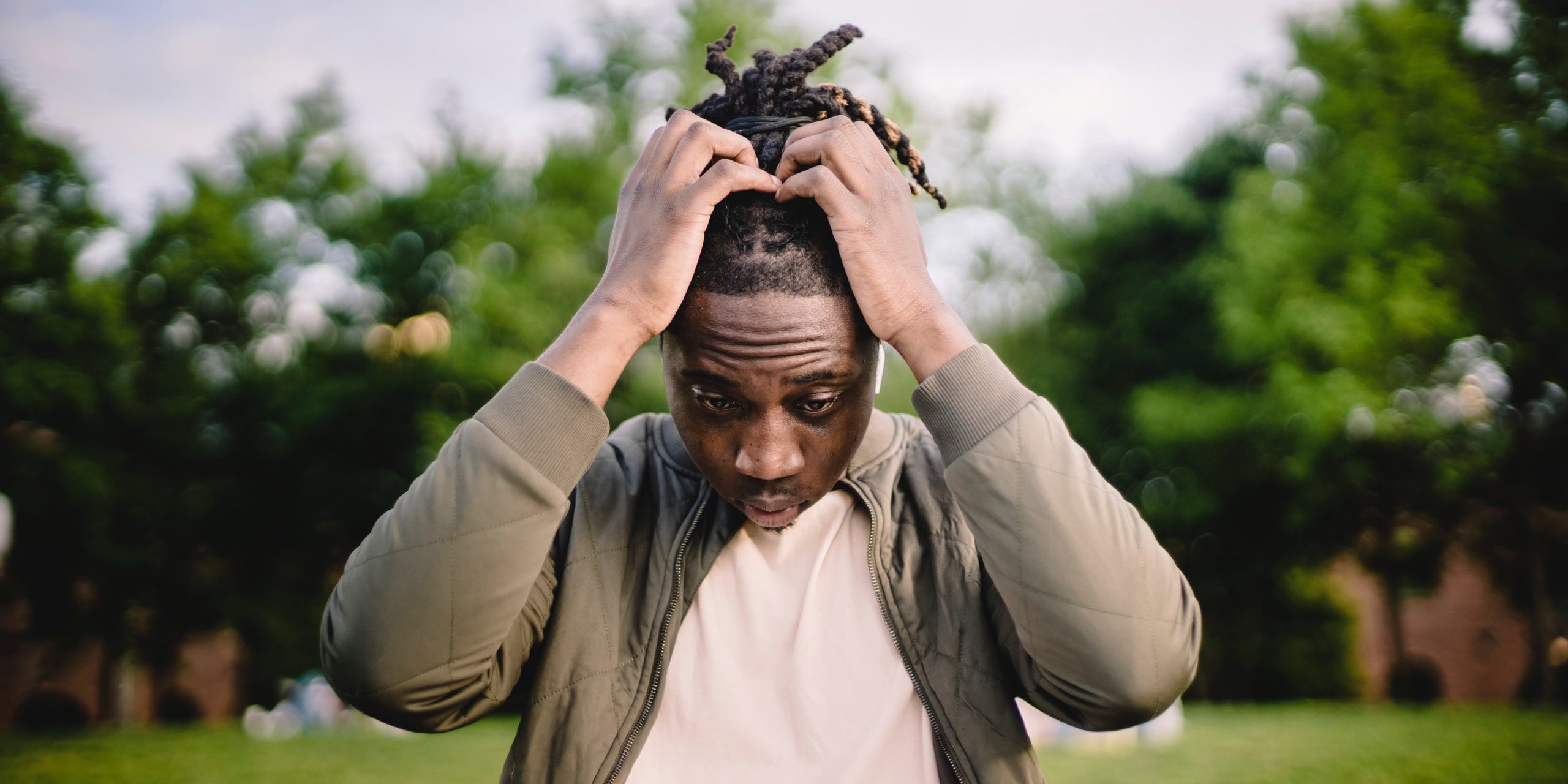 man looks at computer in distress